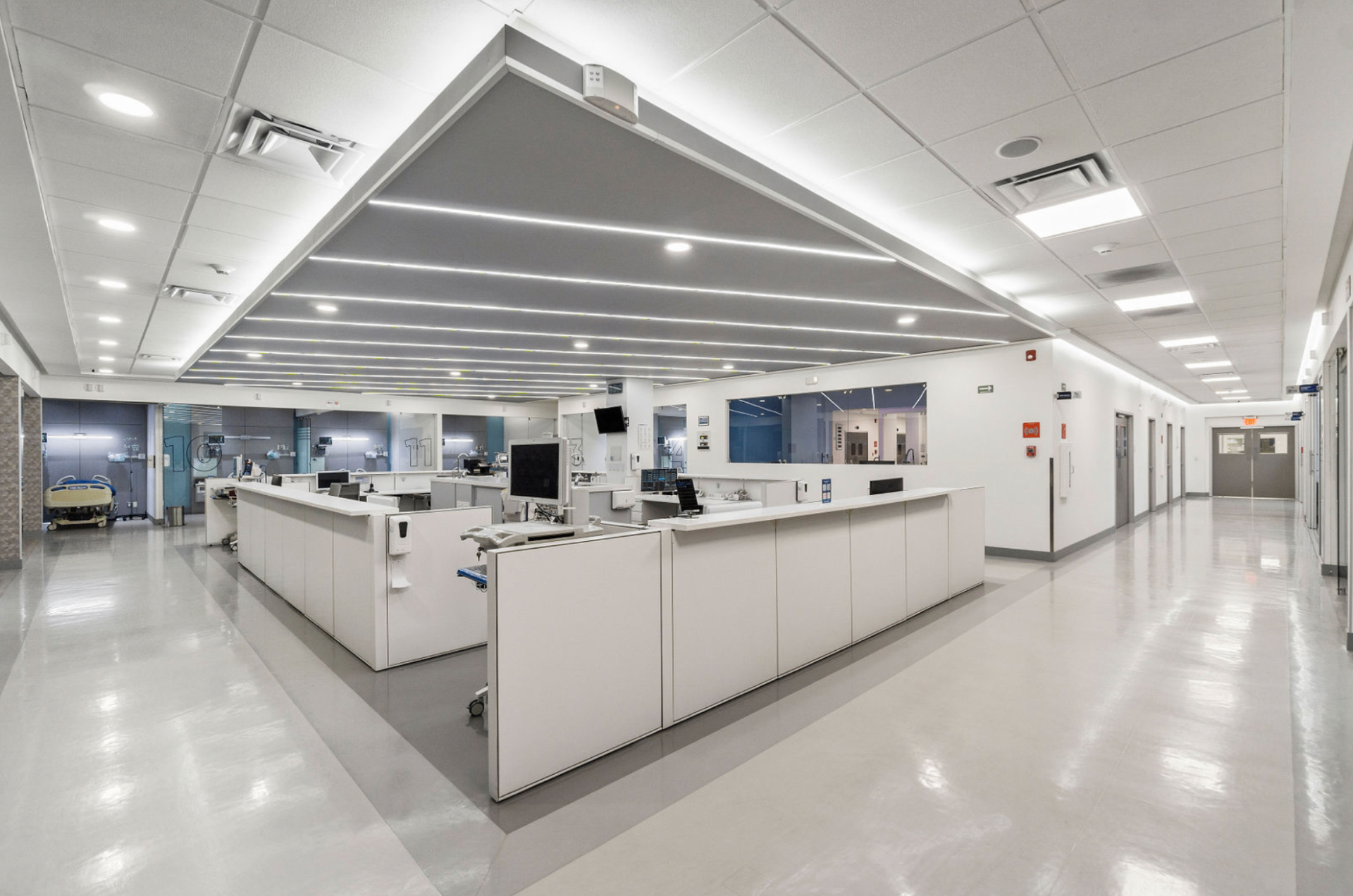 Modern hospital interior with bright corridor and nurses' station